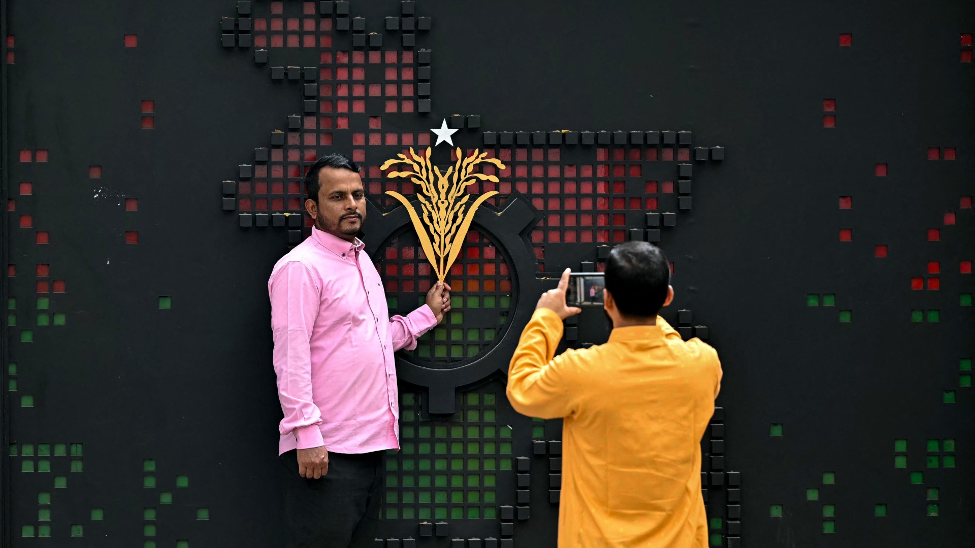 People take a photograph outside the office of Bangladesh Nationalist Party (BNP) chairman Tarique Rahman, in Dhaka on February 13, 2026. 