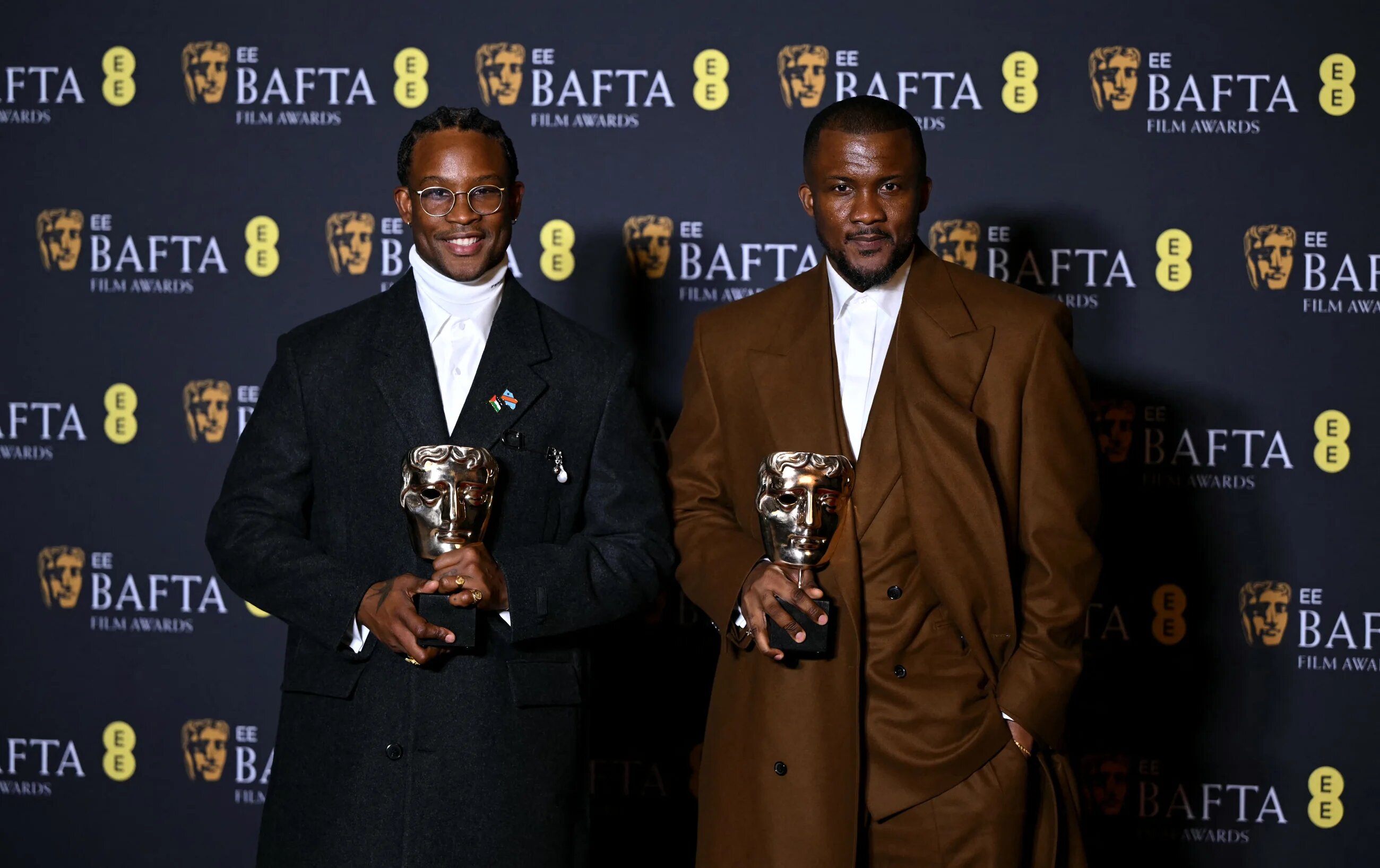 British-Nigerian director Akinola Davies Jr and screenwriter Wale Davies pose with the award for Best Outstanding Debut by a British Writer, director or producer for the film My Father's Shadow during the Baftas in London on 22 February 2026 (Justin Tallis/AFP)