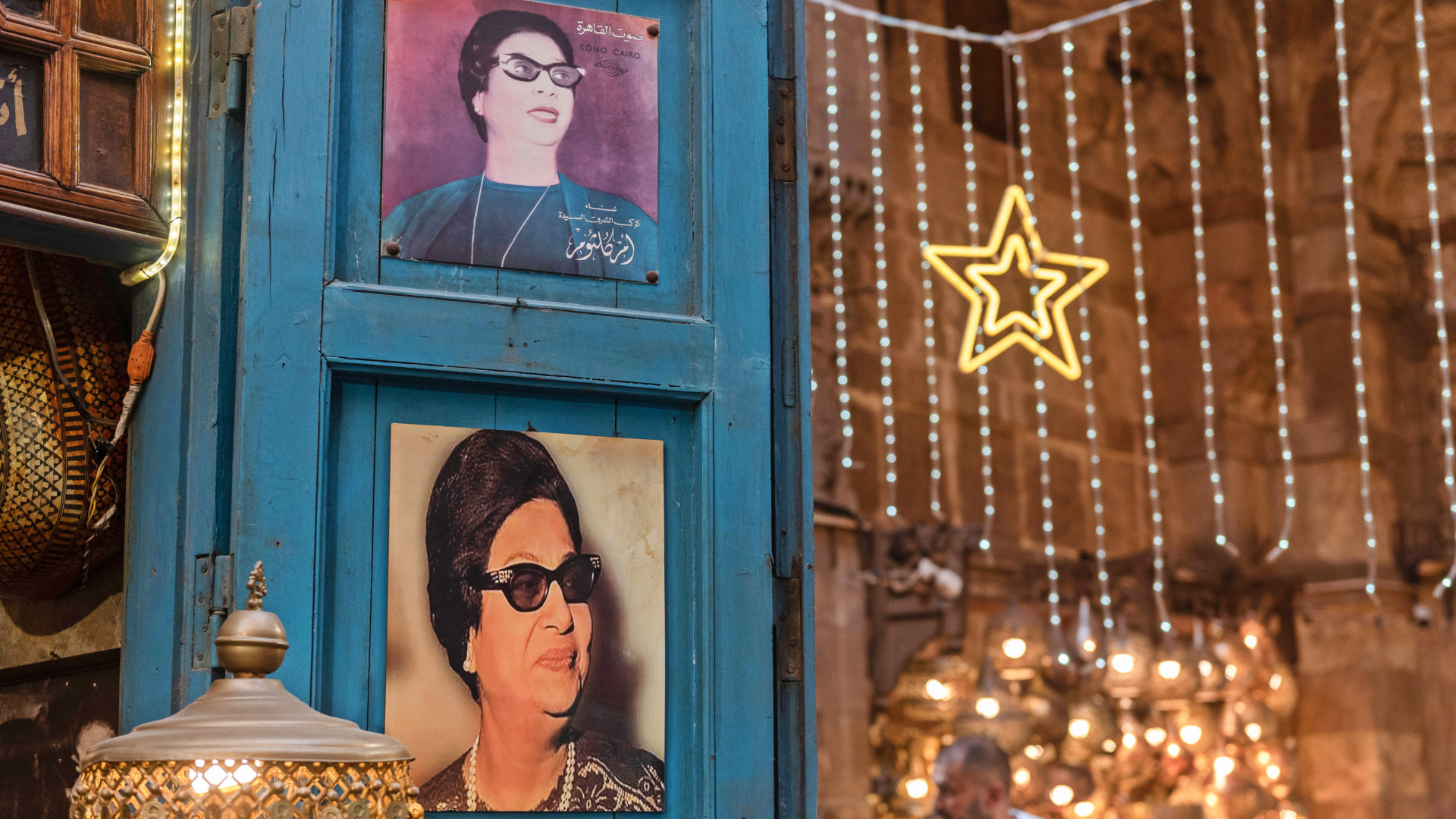 Portraits of Umm Kulthum, the Egyptian singer, songwriter and film actress who became an icon across the Middle East, on display in a cafe in Cairo on 2 July 2024 (John Wreford/SOPA Images via Reuters)