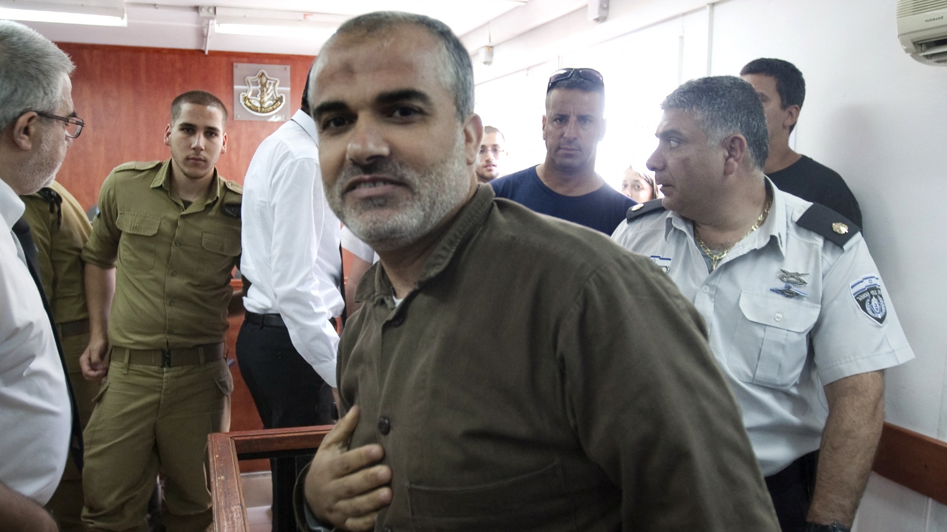 Ibrahim Hamed arrives in the dock at the Ofer military court, near the West Bank city of Ramallah, on July 1, 2012 (Ahmad Gharabli/AFP)