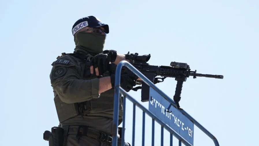 A member of Israel’s security forces stands guard in an area that was reportedly hit by an overnight Iranian strike, in Tel Aviv on 1 March 2026 (Ilia Yefimovich/AFP)