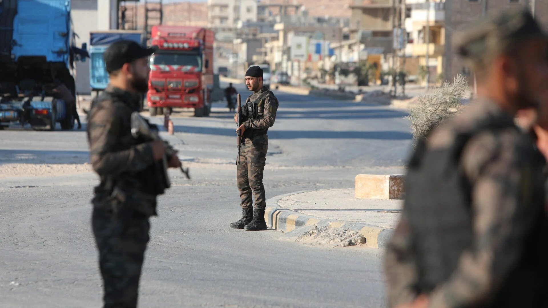 Fighters in a faction of the Turkey-backed Syrian National Army man a checkpoint in the Tal Battal area near al-Bab city on 26 September 2023 (AFP/Bakr Alkasem)