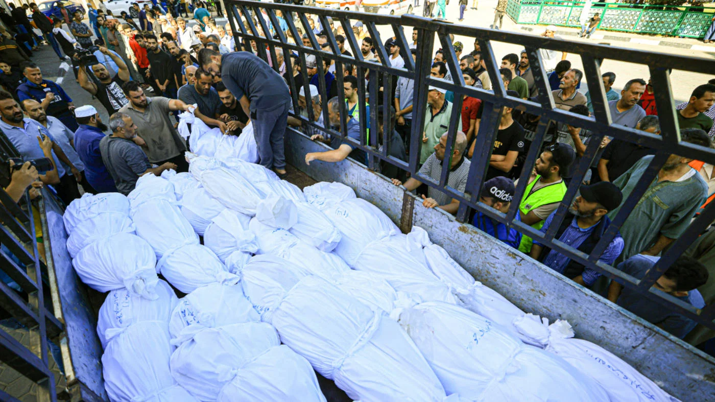 A lorry carries the bodies of the Abu al-Awf family and others in in central Gaza on 15 October 2023 (AFP)