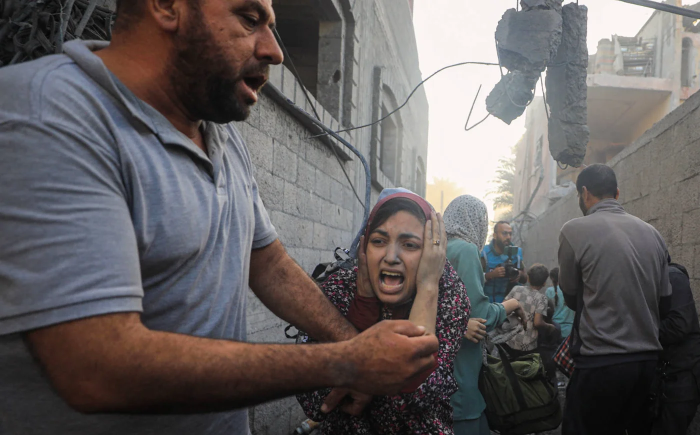 People flee following Israeli air strikes on a neighbourhood in the al-Maghazi refugee camp in the central Gaza Strip on 6 November 2023 (AFP)
