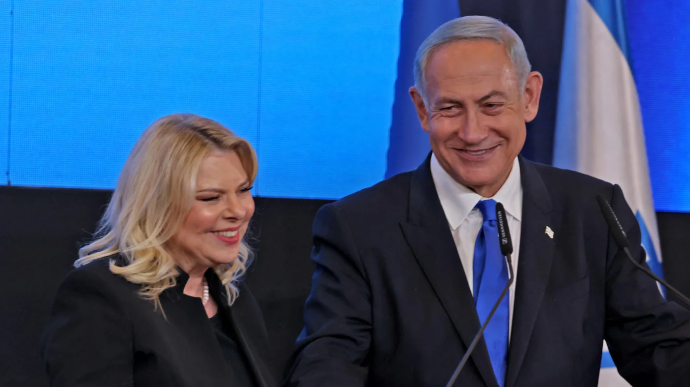 Benjamin Netanyahu addresses supporters, flanked by his wife Sara, at campaign headquarters in Jerusalem on 2 November 2022, after the end of voting for national elections (AFP)