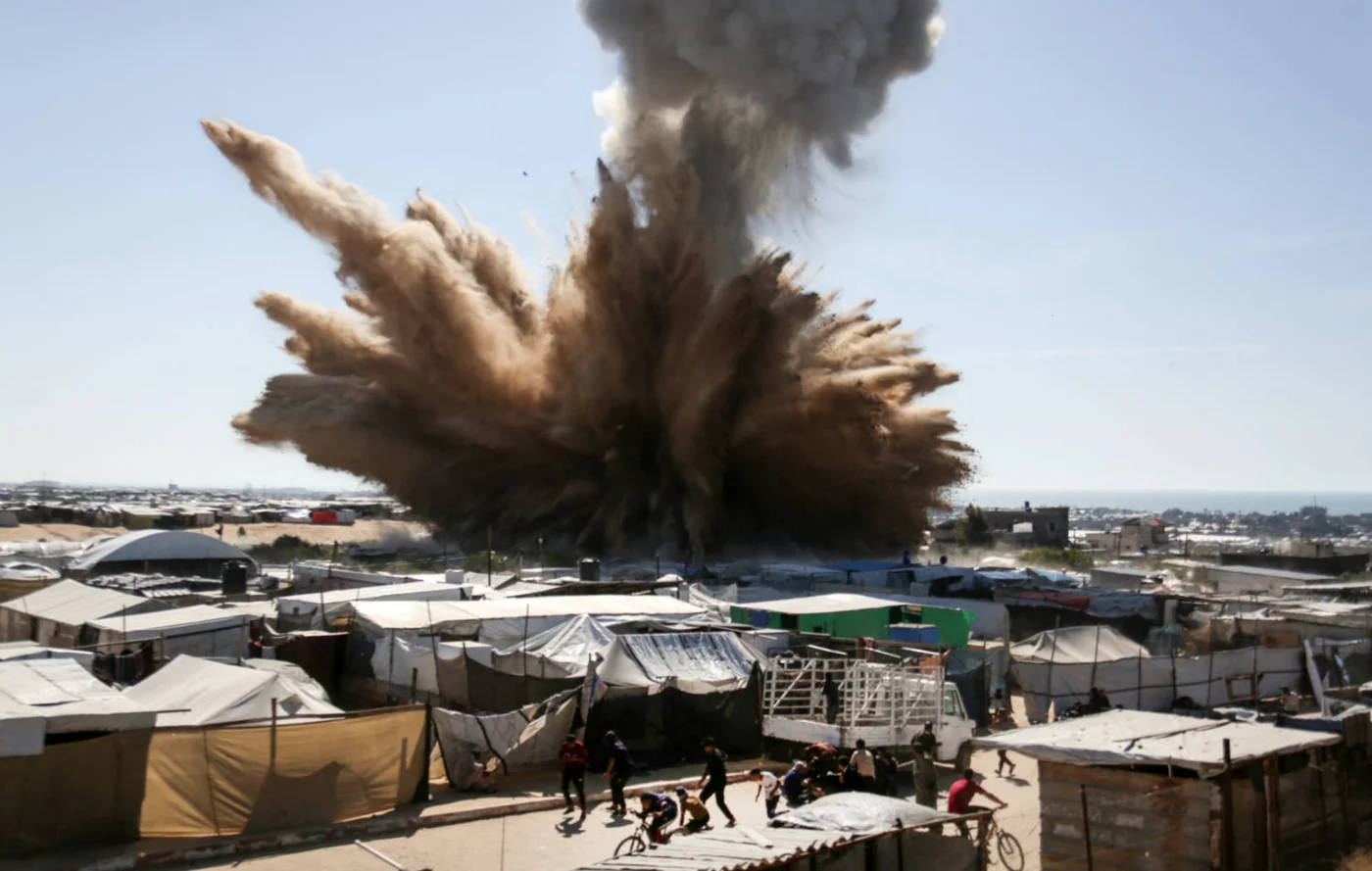 People flee after an Israeli strike hits camp for displaced Palestinians in northern Khan Yunis, southern Gaza Strip, in April 2025 (AFP)