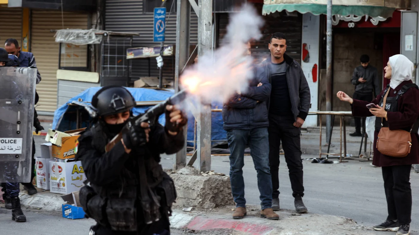 Palestinian Authority (PA) forces fire tear gas to disperse a protest against their security operation, in Jenin, West Bank, on 16 December 2024.