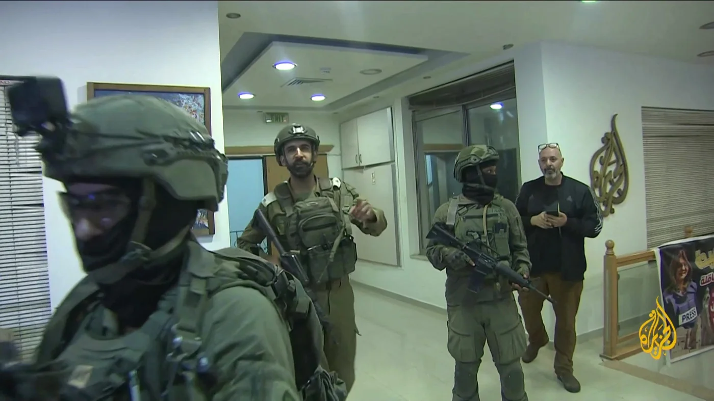 Israeli soldiers enters the offices of al Jazeera in Ramallah, West Bank, in September 2024 (AFP/al Jazeera)